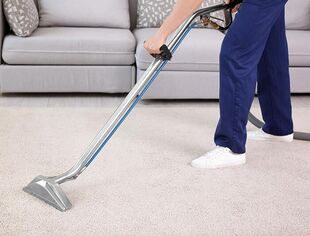 person cleaning carpet with machine